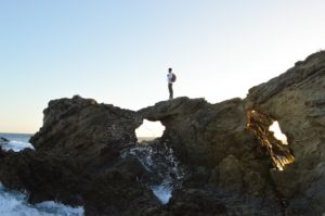 Man on Rock over Ocean - Confidence for Introverted Men