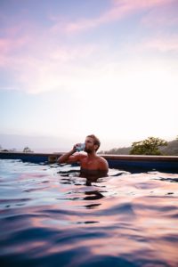 Man Drinking Beer in Pool - Dating Relationship Standards Introverted Alpha
