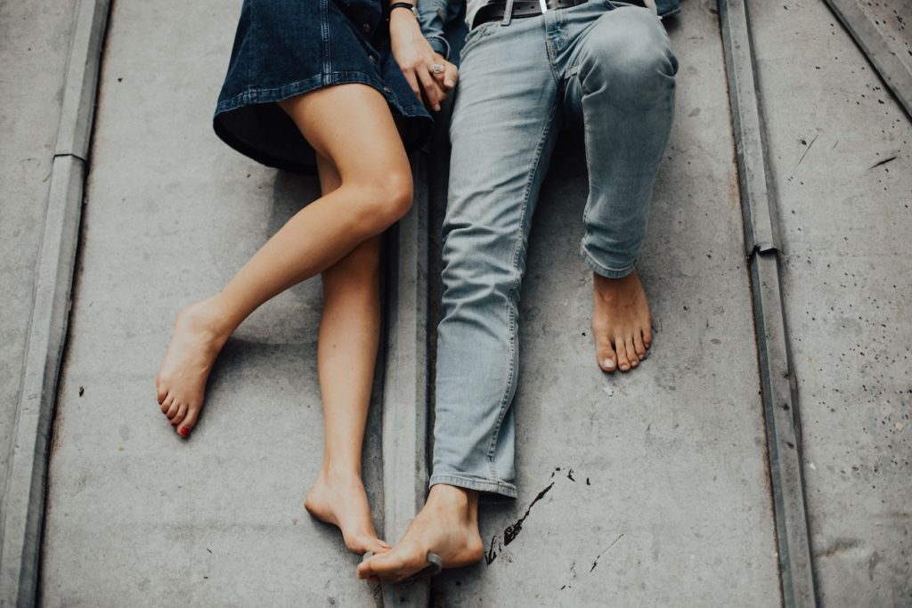 Couple lying down on a roof - Launch Your Dating Life - Introverted Alpha