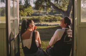 man and woman laughing in doorway - how to flirt without it seeming like you're flirting