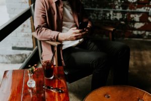 man sitting in chair texting - texting a girl for the first time