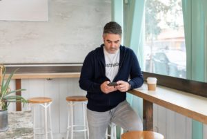 man texting at coffee bar - she's not texting back