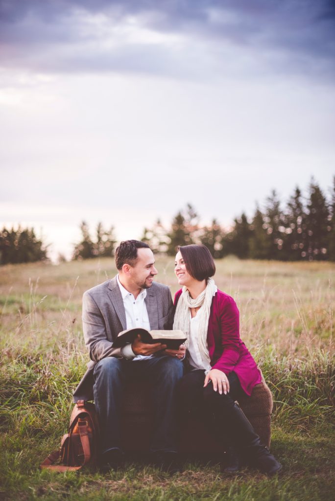 Couple In Field With Bible - Christians In Love