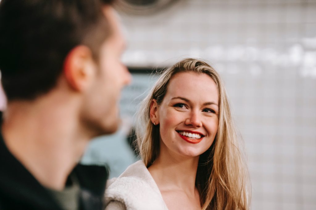 Woman Smiling At Man - How to Know if She Likes You