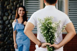 Woman and Man Holding Flowers - Introverted Dating